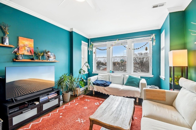 living room featuring ornamental molding, wood finished floors, and visible vents