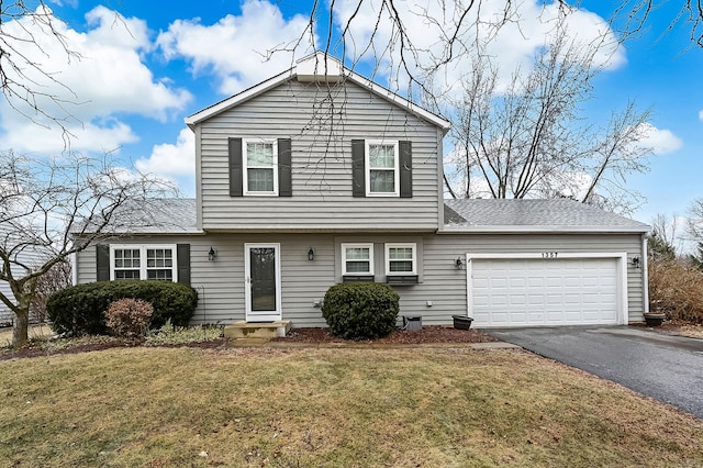 view of front of property with a garage and a front lawn