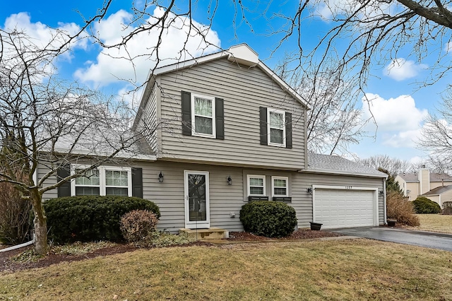 front of property featuring a garage and a front lawn