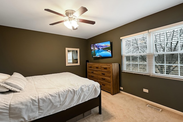 bedroom featuring light colored carpet and ceiling fan