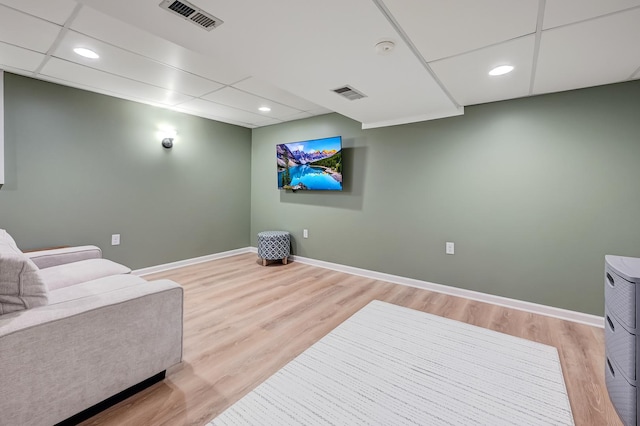 home theater featuring a drop ceiling and light hardwood / wood-style floors