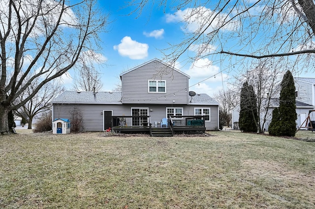 back of house featuring a deck and a lawn