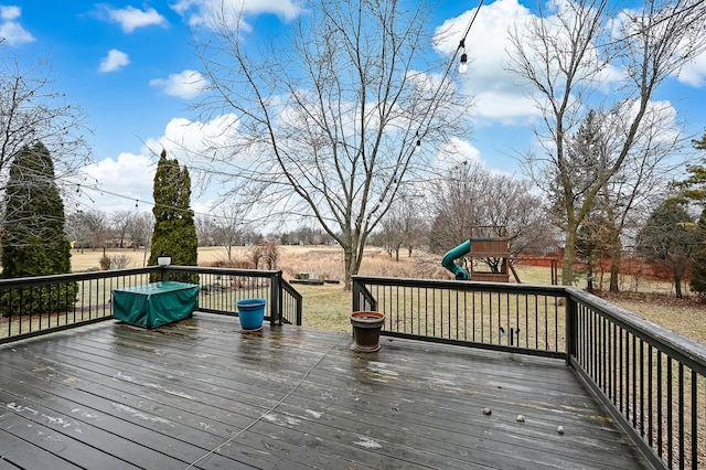 wooden deck featuring a playground