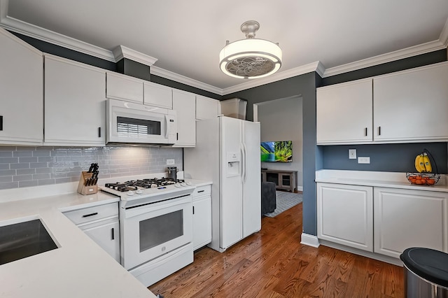 kitchen with crown molding, white appliances, backsplash, wood-type flooring, and white cabinets