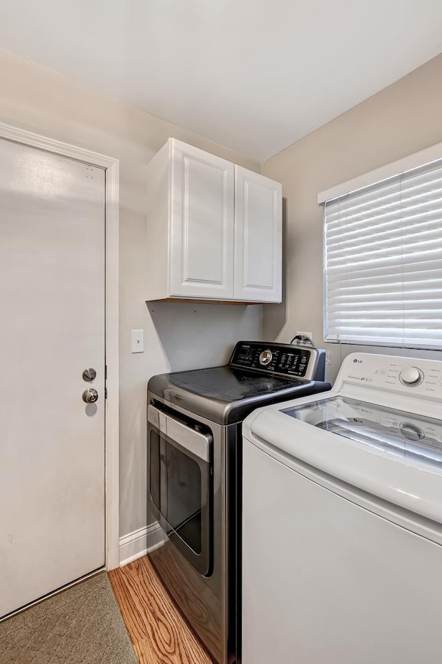 washroom featuring cabinets and independent washer and dryer