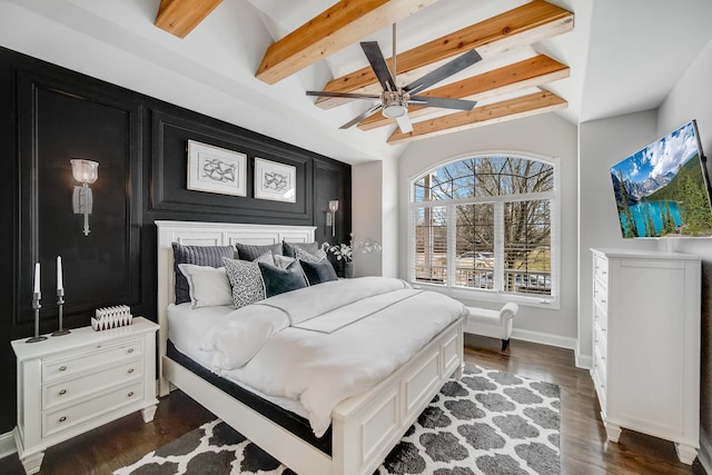 bedroom featuring ceiling fan, dark hardwood / wood-style flooring, and vaulted ceiling with beams