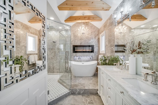 bathroom with shower with separate bathtub, a chandelier, vaulted ceiling, tile walls, and vanity