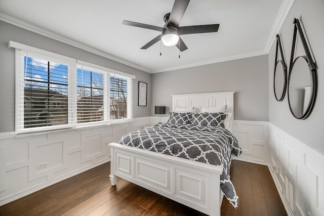 bedroom featuring ornamental molding, dark wood-type flooring, and ceiling fan