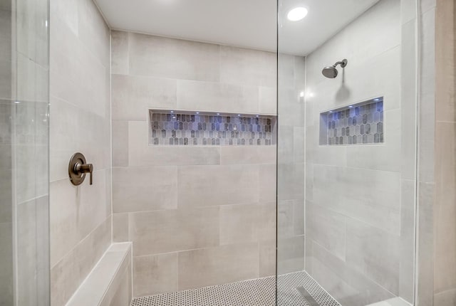 bathroom with tiled shower