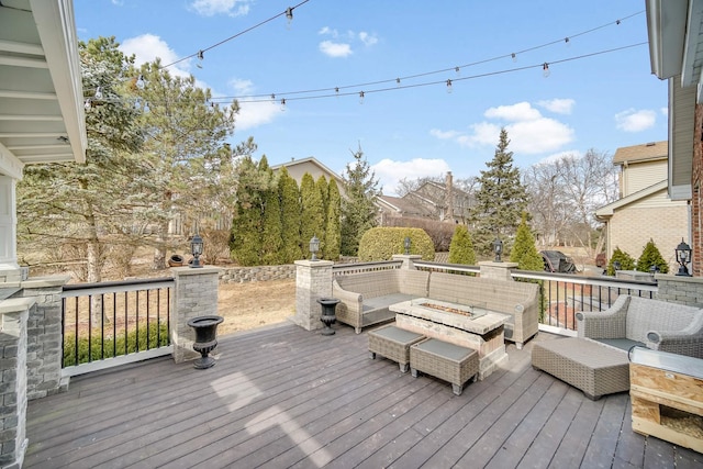 wooden deck with an outdoor living space with a fire pit