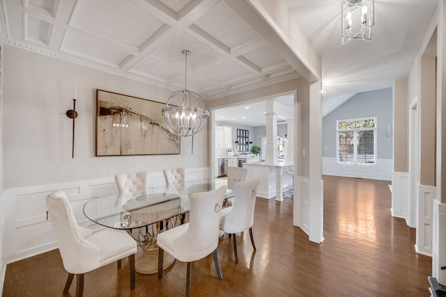 dining room with dark wood-type flooring, an inviting chandelier, beam ceiling, coffered ceiling, and ornate columns