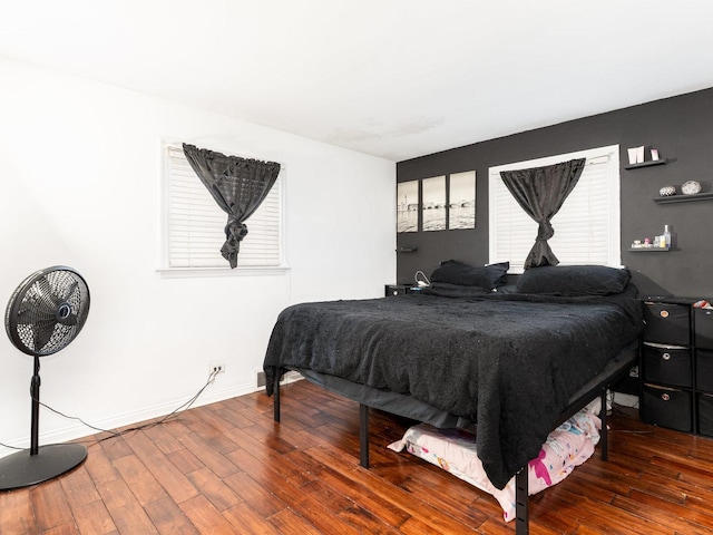 bedroom featuring wood finished floors and baseboards