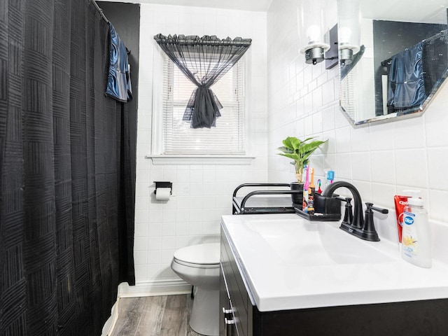 bathroom with vanity, tile walls, toilet, and wood finished floors