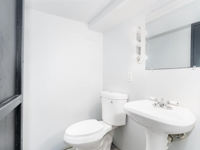 half bathroom with a sink and toilet