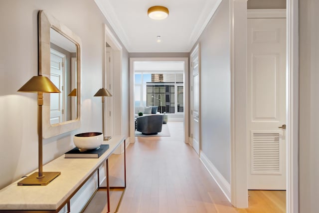 hallway featuring light hardwood / wood-style flooring and ornamental molding