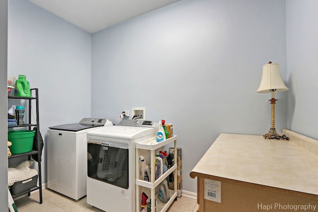 laundry room with light tile patterned floors and washer and dryer