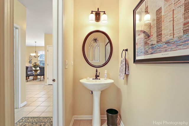 bathroom featuring tile patterned floors and an inviting chandelier