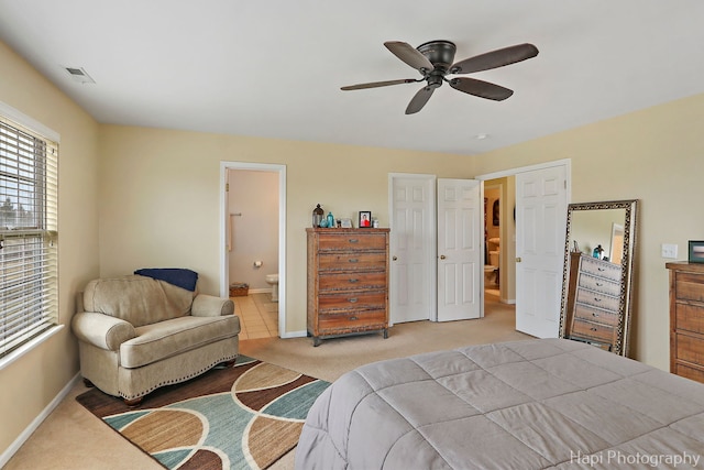 carpeted bedroom featuring connected bathroom and ceiling fan