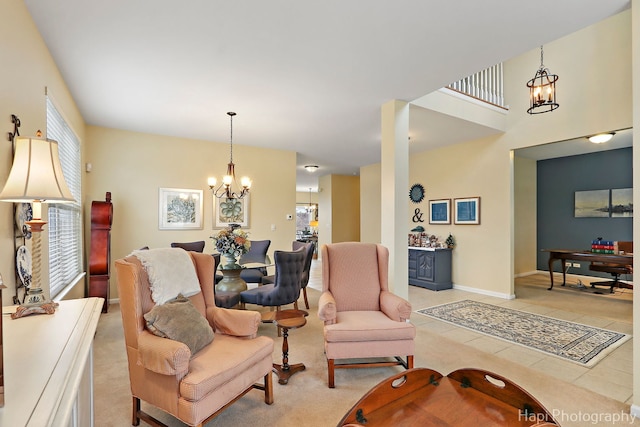 living room with an inviting chandelier and light tile patterned floors