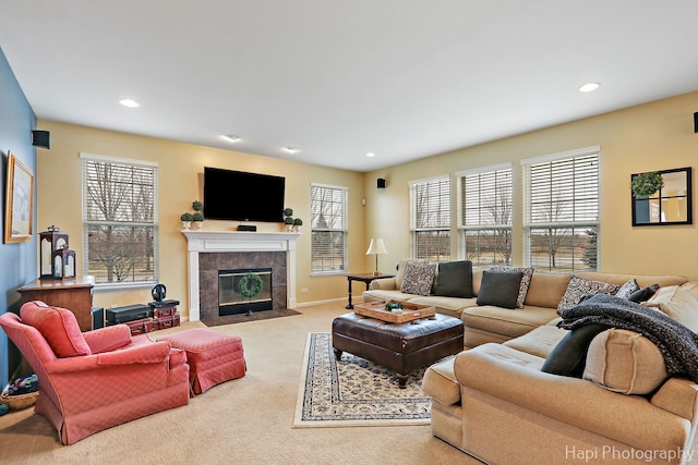 living room featuring a fireplace and light carpet