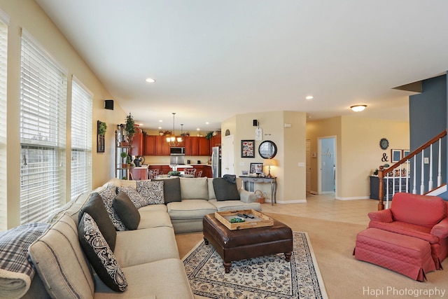 living room featuring light carpet and a chandelier