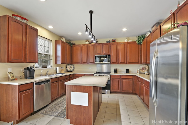 kitchen with pendant lighting, light tile patterned floors, stainless steel appliances, and a kitchen island