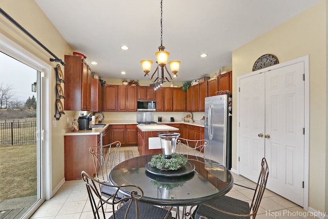 tiled dining room with sink and a chandelier