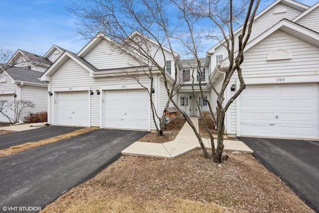 view of property featuring aphalt driveway and a garage