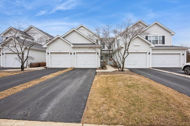 traditional-style house with driveway and a front yard