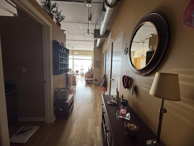 hallway with hardwood / wood-style floors