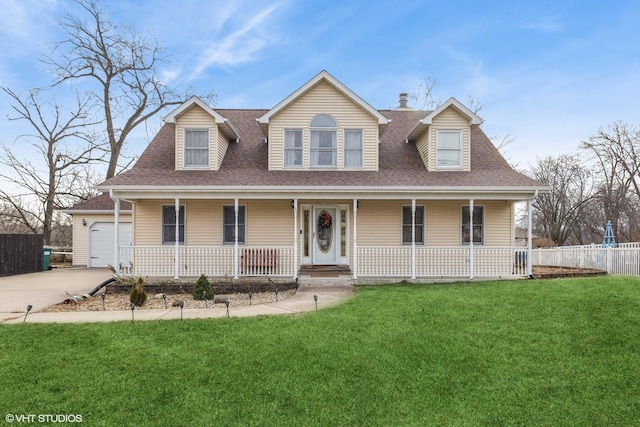 view of front of house featuring a garage, a front lawn, and covered porch