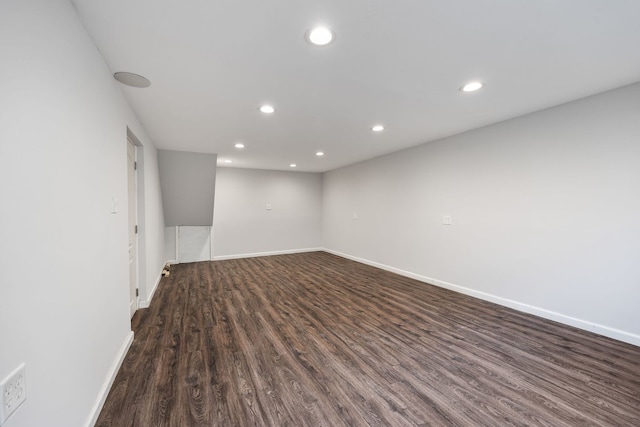 empty room with dark hardwood / wood-style flooring