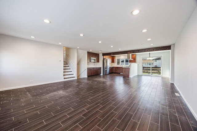 unfurnished living room featuring dark wood-type flooring