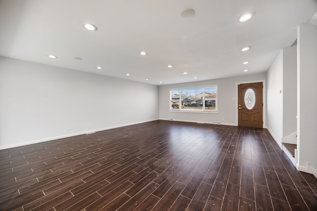 unfurnished living room with dark wood-type flooring