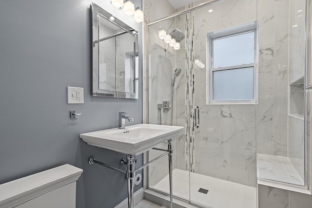 bathroom with sink, an enclosed shower, and toilet