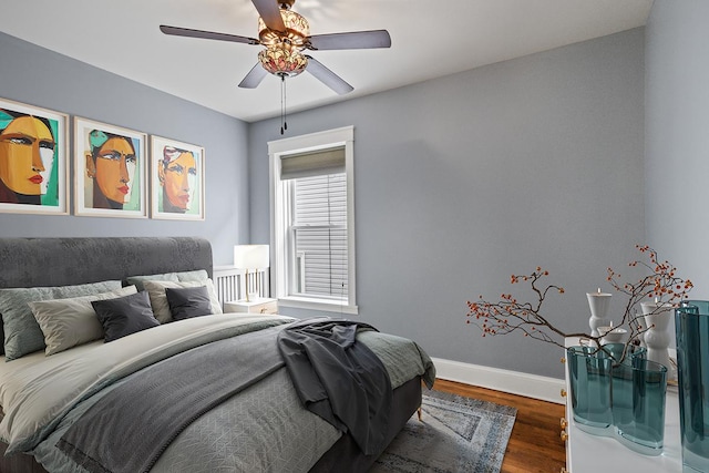 bedroom with ceiling fan and dark hardwood / wood-style flooring