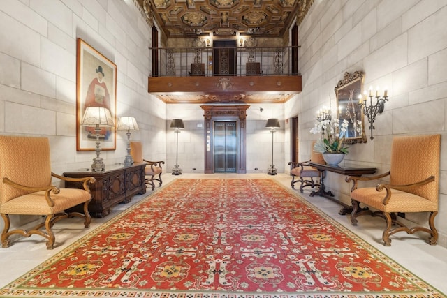 interior space with elevator and a high ceiling