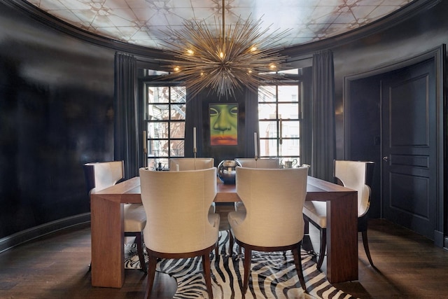 dining space with dark wood-style flooring, crown molding, and baseboards