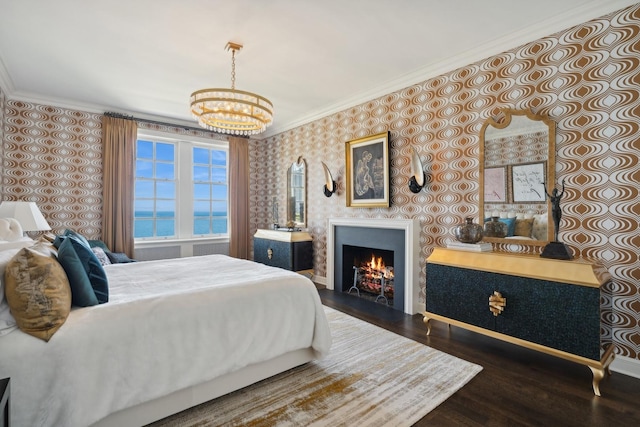 bedroom featuring ornamental molding, dark wood-style flooring, a water view, and wallpapered walls