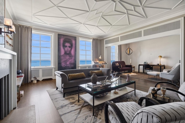 living area featuring a water view, crown molding, baseboards, and wood finished floors