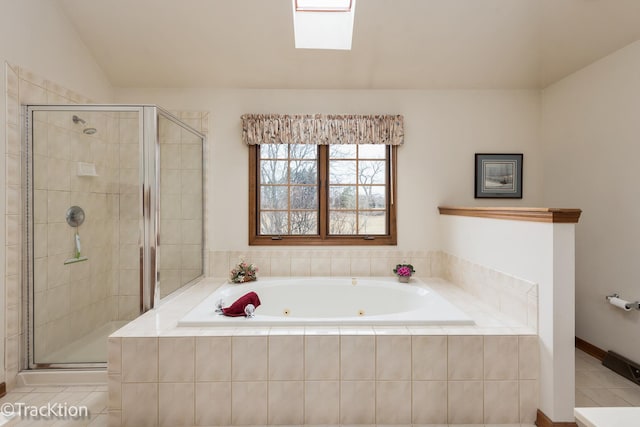 bathroom with tile patterned floors, lofted ceiling with skylight, and independent shower and bath