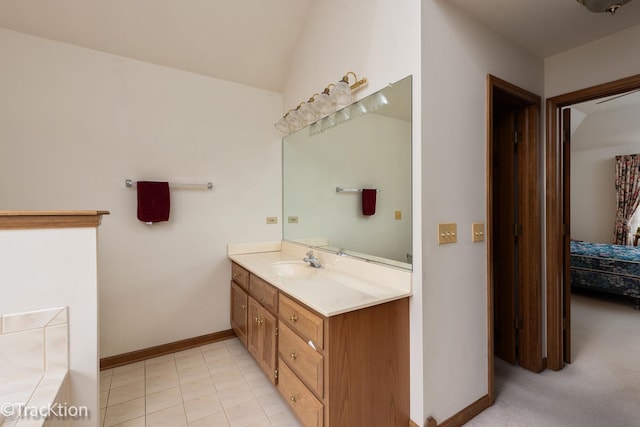 bathroom featuring vanity, vaulted ceiling, and tile patterned floors