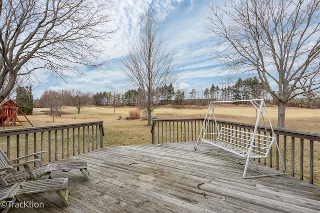 wooden terrace with a yard and a playground