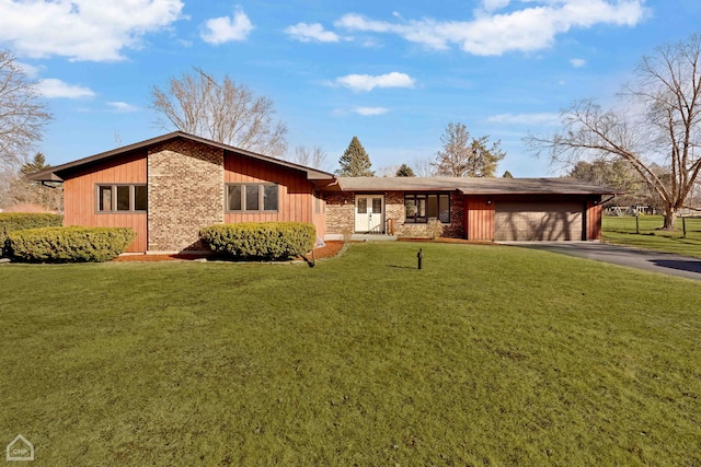 ranch-style home featuring a garage and a front lawn