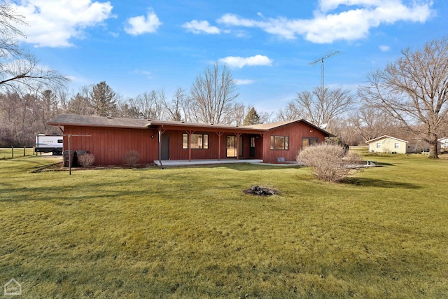 back of house with a lawn