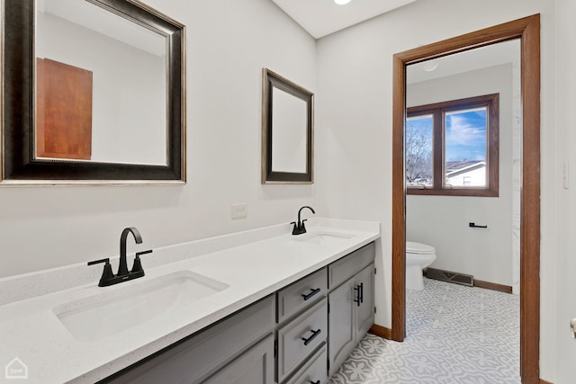 bathroom featuring vanity and toilet