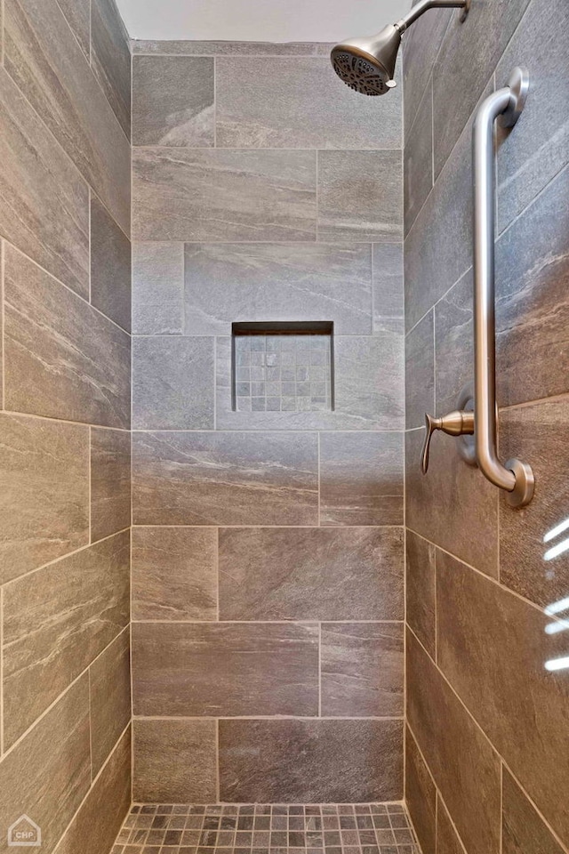 bathroom with a tile shower