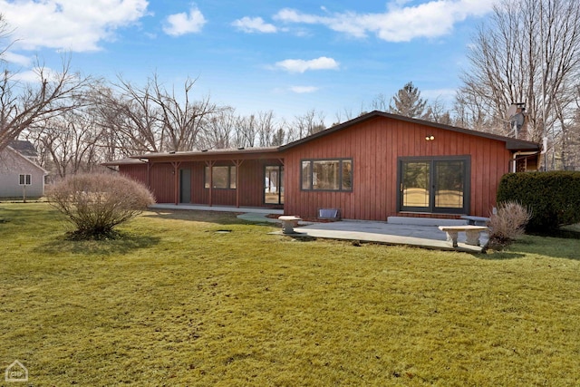 rear view of house featuring a lawn