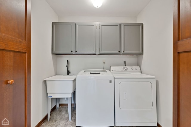 clothes washing area featuring cabinets and washing machine and dryer