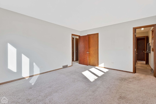 unfurnished room with light carpet